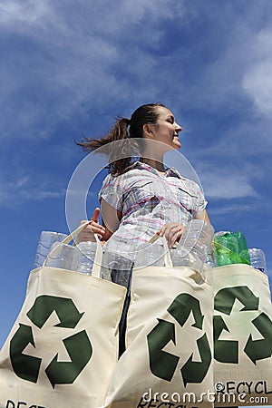 Recycling: woman holding bag with plastic bottles Stock Photo