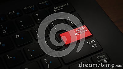 Red ABORT MISSION button on a black keyboard background - terminate before completion concept Stock Photo