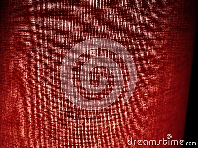 Red abstract background made of fabric. Macro image. Weaving tap-colored pits with black shadows and vignettes Stock Photo