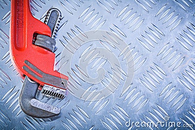 Red adjustable monkey wrench on corrugated metallic sheet copysp Stock Photo