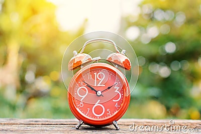 Red alarm clock on old wood Stock Photo