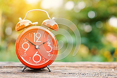 Red alarm clock on old wood Stock Photo