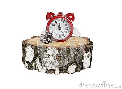 Red alarm clock on a round birch timber on a white background Stock Photo
