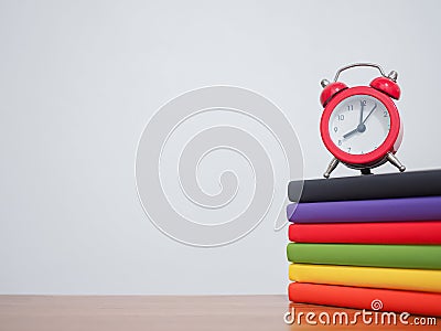 Red alarm on stack hardcover book, Copy space for text, Back to school concept Stock Photo