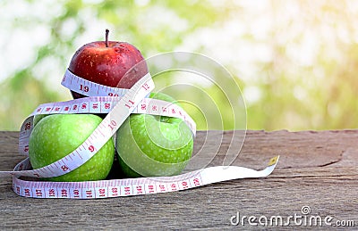 Red apple and green apple with measuring tape. Stock Photo