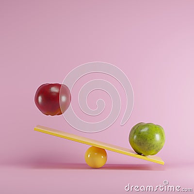 Red apple and green apple playing on yellow seesaw on blue background Stock Photo