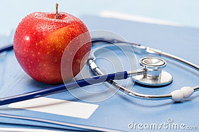 Red apple and medical stethoscope heathcare Stock Photo