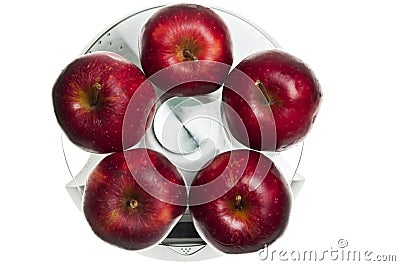 Red apples on food scale Stock Photo