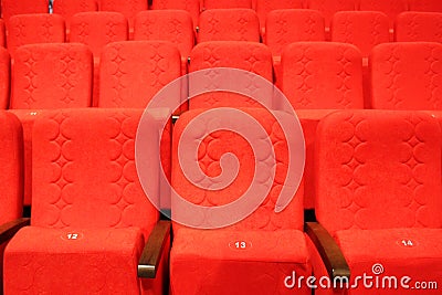 red armchairs. Empty concert hall, theater chairs background ... color photo, empty cinema or concert hall. The red Stock Photo