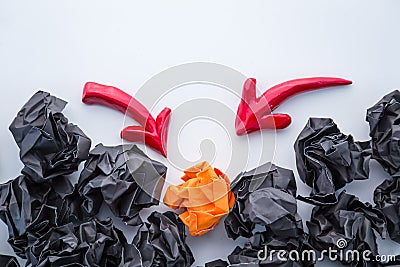 Red arrow aim to orange crumpled paper Stock Photo