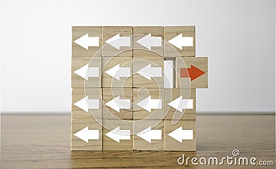 Red arrow print screen on wooden cube changing direction with white arrow. It is business disruption and different thinking idea Stock Photo