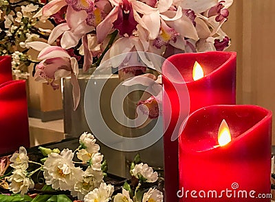 Red Artificial Candles at The Corner with Group of Variety Flowers used as Vintage Style Decoration in Luxury Bedroom Stock Photo