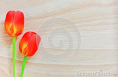 Red artificial tulips on wood background, copy space Stock Photo