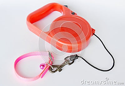 Red automatic leash and pink nylon dog collar on white background Stock Photo