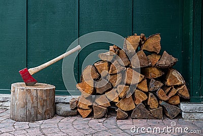 Red Axe and Pile of Fire Wood Stock Photo