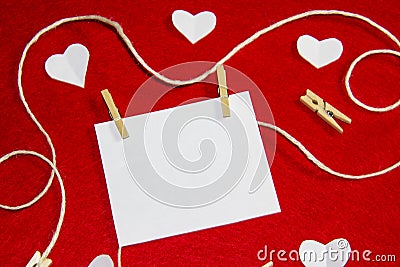 A red background from felt. A composition from heart, thread and clothespins. Background with place for write for valentines day Stock Photo