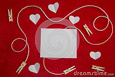 A red background from felt. A composition from heart, thread and clothespins. Background with place for write for valentines day Stock Photo