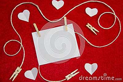 A red background from felt. A composition from heart, thread and clothespins. Background with place for write for valentines day Stock Photo