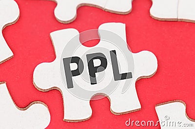 On a red background, among white puzzles lies a puzzle with the inscription - PPL Stock Photo