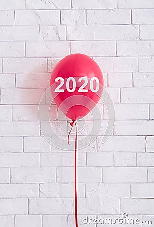 Red balloon with 2020 concept in front of white bricks wal Stock Photo