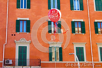 Red balloon with orange building on background Editorial Stock Photo