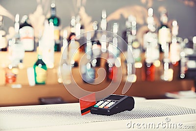 Red bankcard inserted in reader on defocused background. Stock Photo