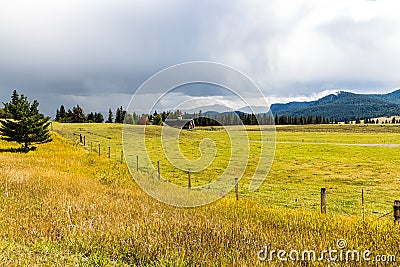 Red Barn With Mountains In The Distance Stock Photo