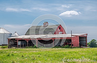 Red Barn and Outbuilding on a Sunny Farm Stock Photo