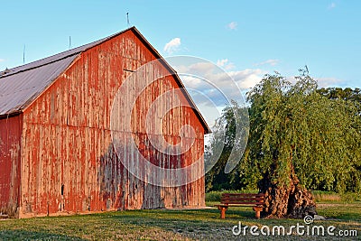 Red barn with tree shadow Stock Photo