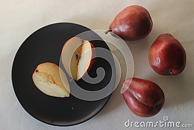 The Red Bartlett pear carries a true pyriform pear shape. A rounded bell on the bottom half of the fruit, then a definitive Stock Photo