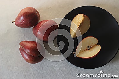 The Red Bartlett pear carries a true pyriform pear shape. A rounded bell on the bottom half of the fruit, then a definitive Stock Photo