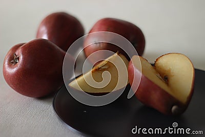 The Red Bartlett pear carries a true pyriform pear shape. A rounded bell on the bottom half of the fruit, then a definitive Stock Photo