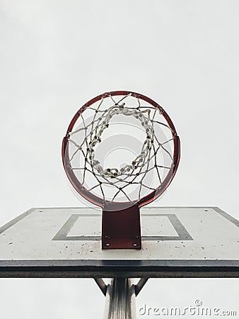 Red basketball hoop from below looking up to the sky ready to jump Stock Photo