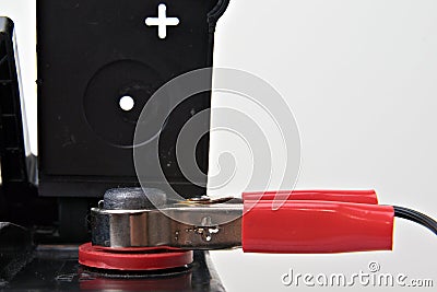 Red battery clamp on 12v battery Stock Photo