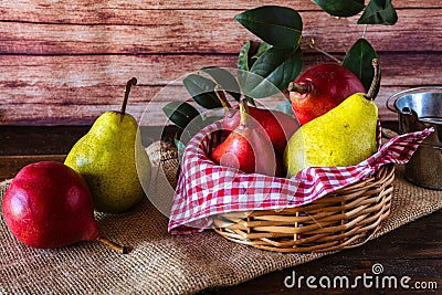 Red battler pears or red pear and packham or green pears in a basket on a table. Organic and natural products Stock Photo