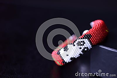 Red beaded bracelet with image of funny panda Stock Photo