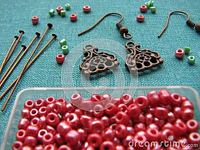 Red beads and pieces for making earrings, handmade jewelry Stock Photo