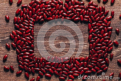 Red beans beautifully laid out on a wooden background. Top view. rectangular copy space. Vegetarian food. Unprepared Stock Photo