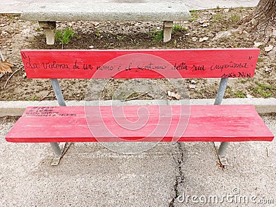 Red bench simbol of violence of woman with emergency number Editorial Stock Photo