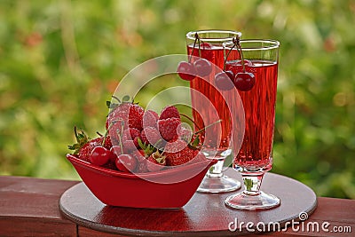 Red berries and red drink glasses Stock Photo