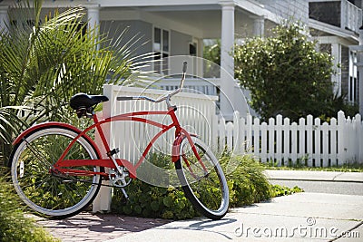 Red bicycle in front of house. Stock Photo