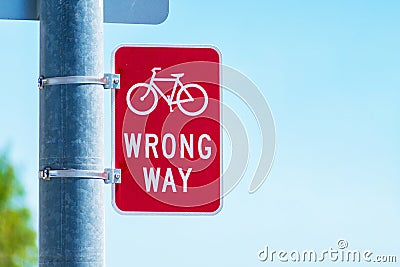 Red bicycle wrong way Sign on street pole Stock Photo