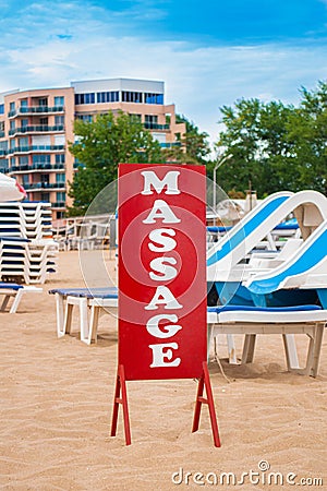 Red big massage sign stands on the beach Stock Photo