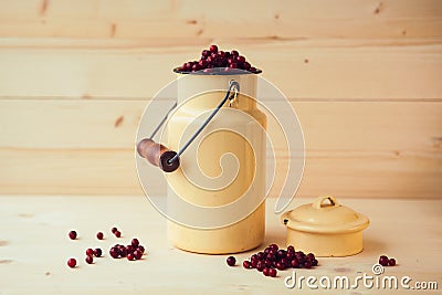 Red bilberry, cowberry, fowberry, redberry. Cranberry in can on wooden background Stock Photo