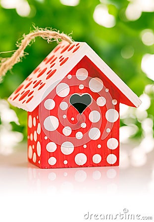 Red birdhouse in white polka dot Stock Photo