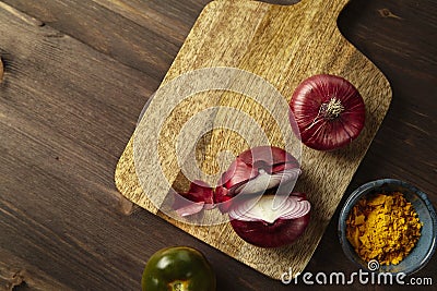 Red bisect onion, tomato, turmeric on wooden table. Close-up fro Stock Photo