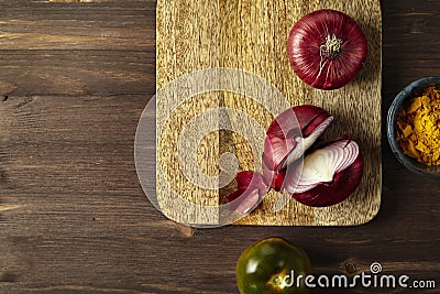 Red bisect onion, tomato, turmeric on wooden table. Close-up fro Stock Photo