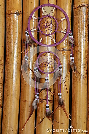 Red black and purple Dreamcatcher with bat made of feathers leat Stock Photo