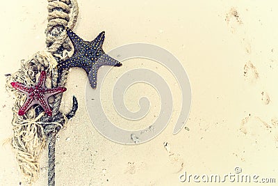 Red and black starfish with knot and anchor on a shore Stock Photo