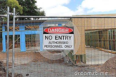 Red, black and white Dana red, black and whiteger, No Entry Authorised Personnel Only warning sign on the fence at a building site Stock Photo